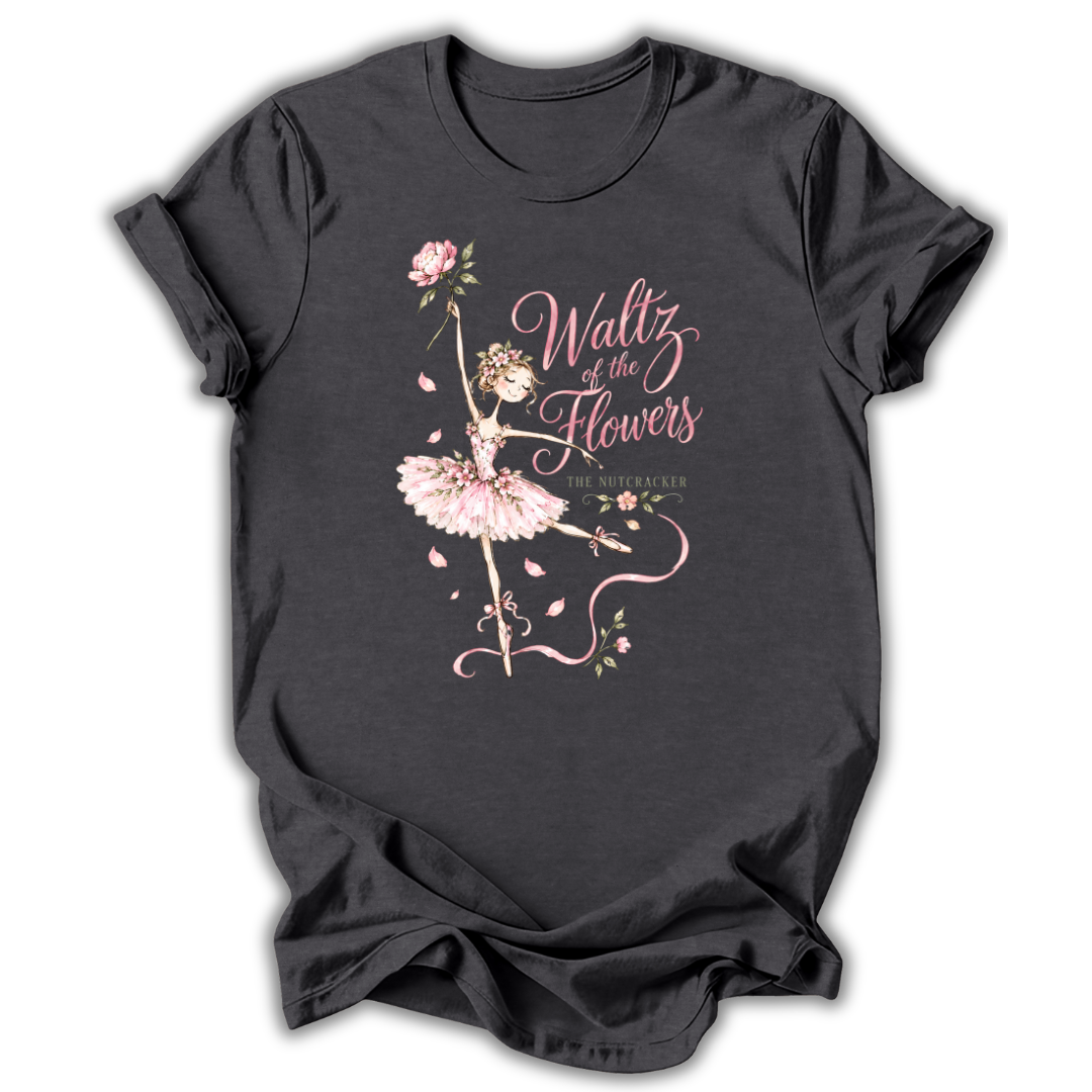 A dark charcoal gray t-shirt with a graphic print of a ballerina in a pink tutu and the text 'Waltz of the Flowers' in pink script, displayed on a clean white background.