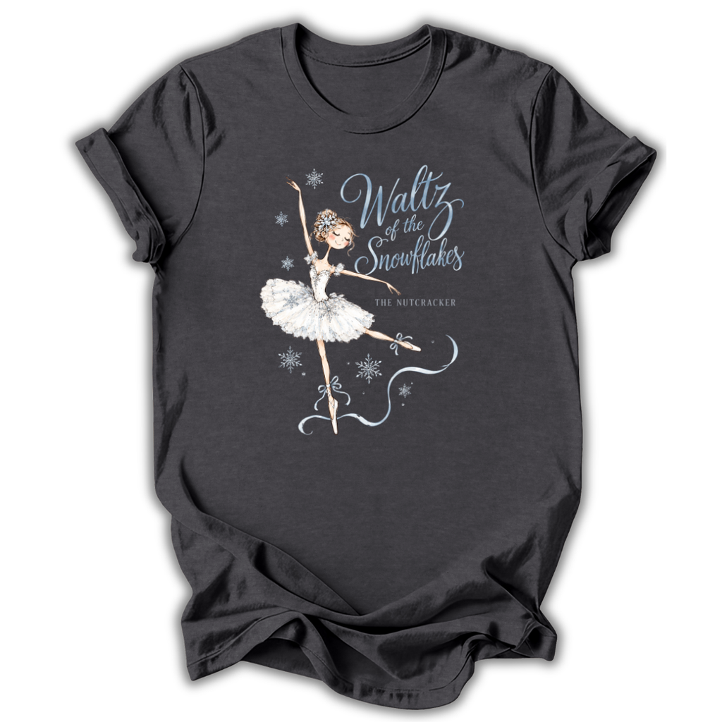 A dark charcoal gray t-shirt featuring a graphic of a ballerina in a white tutu with the text 'Waltz of the Snowflakes' and 'The Nutcracker' printed on the front, displayed against a plain white background.