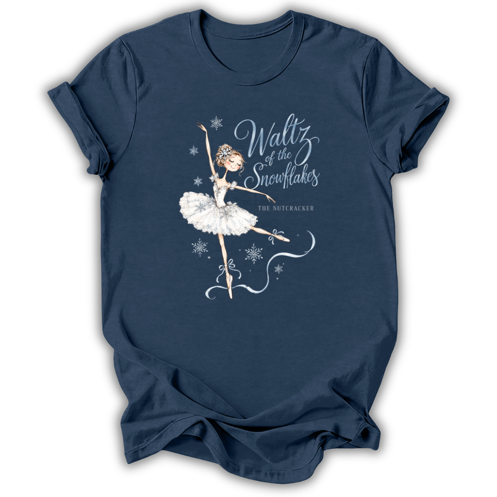 A navy blue short-sleeve t-shirt with a graphic of a ballet dancer in a white tutu and the text 'Waltz of the Snowflakes' and 'The Nutcracker' printed on the front, displayed on a clean white background.