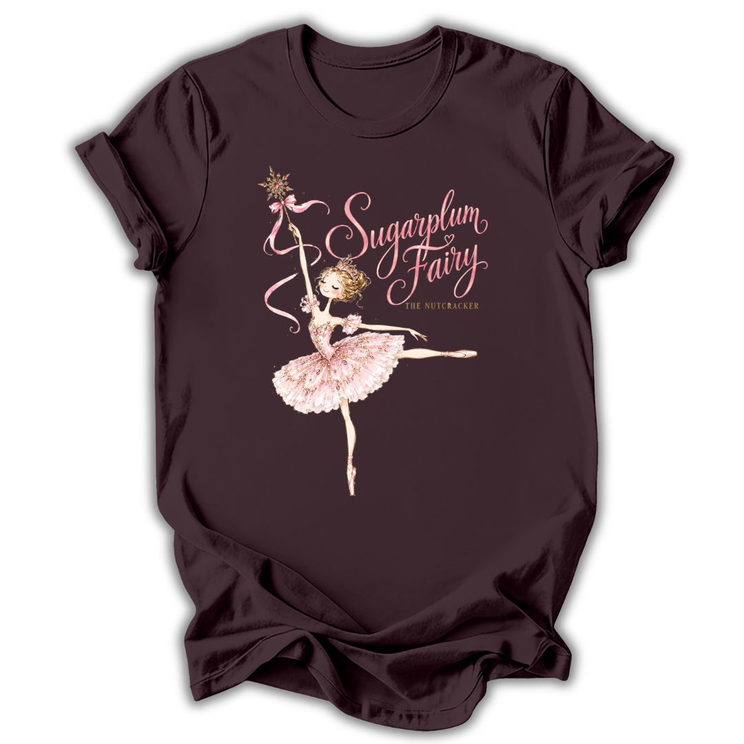 A dark plum short-sleeve t-shirt with a graphic of a ballerina in a pink tutu holding a wand, with the text 'Sugarplum Fairy' and 'The Astronomer' printed on the front.
