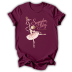 A maroon short-sleeve t-shirt with a graphic of a ballerina and the text 'Sugarplum Fairy' and 'The Asteroid' printed on the front, displayed against a white background.