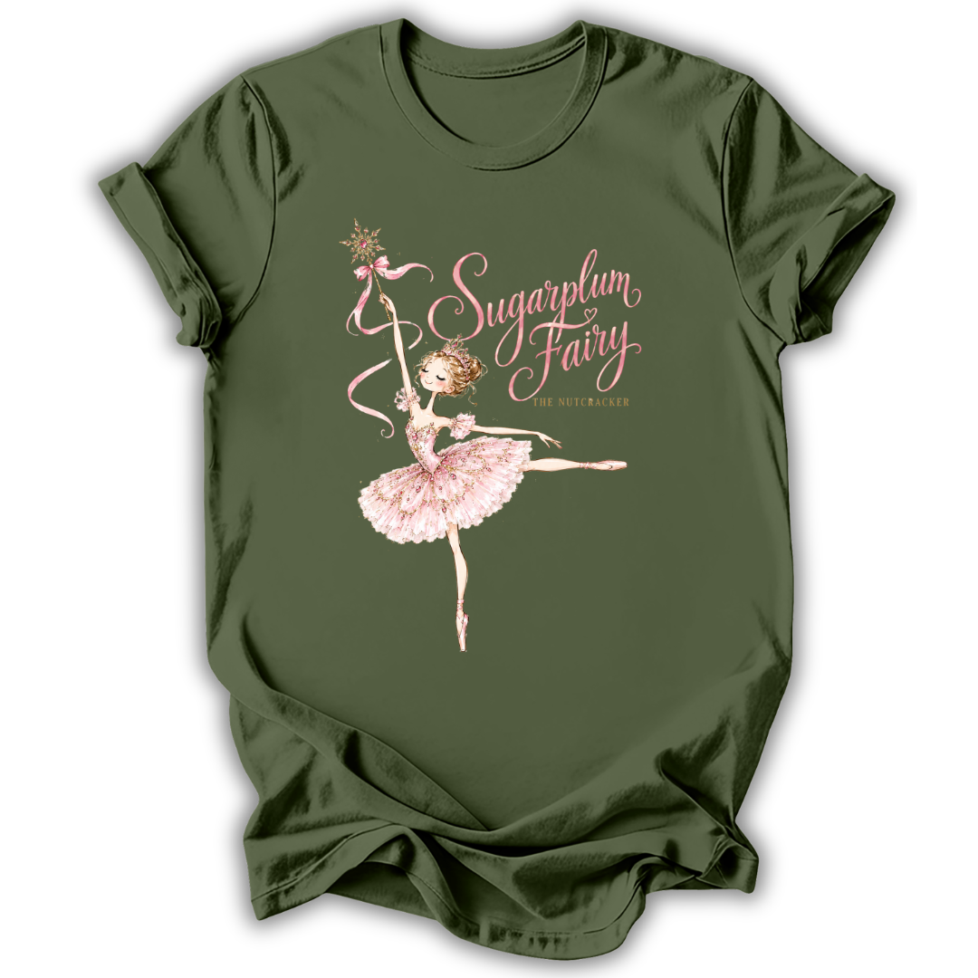 An olive green short-sleeve t-shirt with a graphic of a ballerina in a pink tutu holding a wand, next to the text 'Sugarpum Fairy' and 'The Watercolor' in pink and gold lettering.