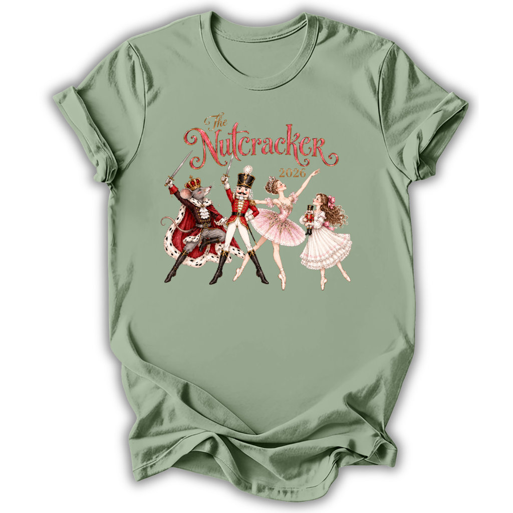 A sage green short-sleeve t-shirt with a vintage-style graphic of 'The Nutcracker' characters (a nutcracker, a ballerina, and a fairy) and the title 'The Nutcracker 2026' printed on the chest.