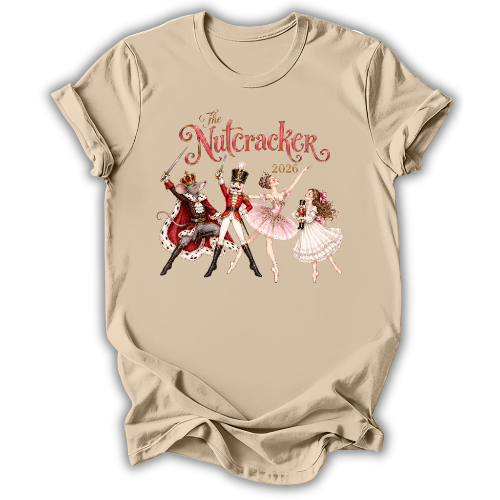 A beige short-sleeve t-shirt with a vintage-style graphic of 'The Nutcracker' characters (a nutcracker, a ballerina, and a fairy) and the title 'The Nutcracker 2026' printed on the chest.