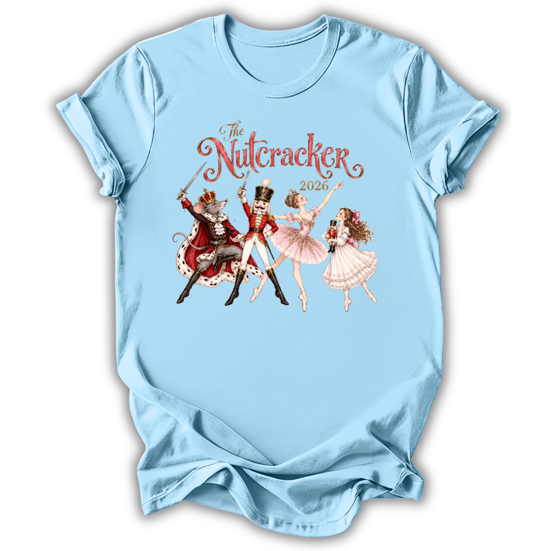 A light blue short-sleeve t-shirt with a vintage-style graphic of 'The Nutcracker' characters from the 2020 holiday season, displayed on a clean white background.