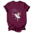 A maroon short-sleeve t-shirt with a graphic of a ballet dancer in a white tutu under the text 'Snow Queen The Nutcracker' with silver snowflakes, displayed on a white background.