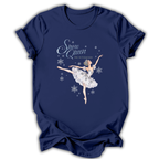 A navy blue short-sleeve t-shirt with a graphic of the Snow Queen from The Nutcracker ballet dancing amidst white snowflakes. The text 'Snow Queen' and 'THE NUTCRAKER' is printed in white and silver on the front.