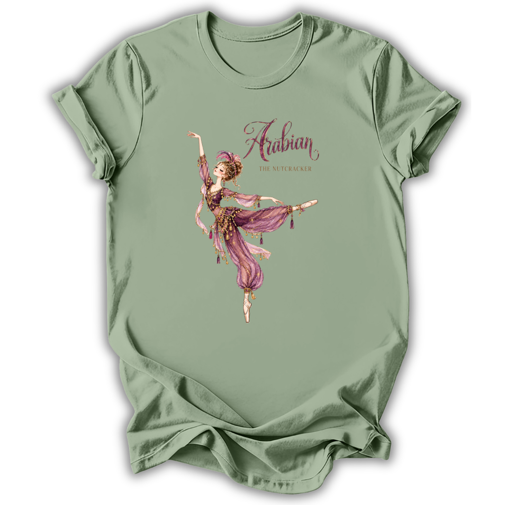 A sage green short-sleeve t-shirt with a graphic print of a ballerina in a pink and purple outfit under the text 'Arabian Nights'.