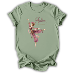 A sage green short-sleeve t-shirt with a graphic print of a ballerina in a pink and purple outfit under the text 'Arabian Nights'.