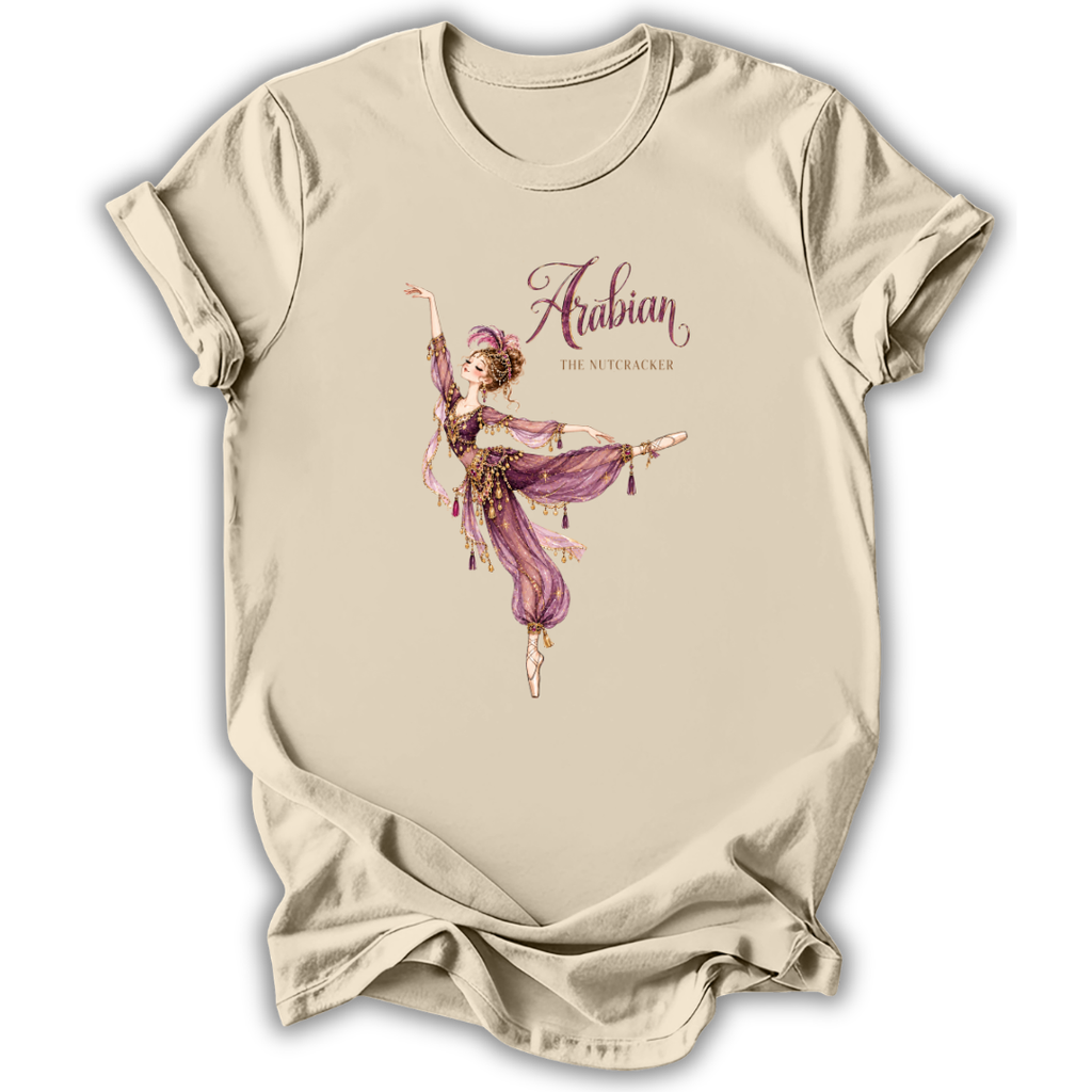 A beige short-sleeve t-shirt with a graphic print of an Arabian-themed dancer in purple and gold, with the text 'Arabian The Nutcracker' on the front.