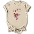 A beige short-sleeve t-shirt with a graphic print of an Arabian-themed dancer in purple and gold, with the text 'Arabian The Nutcracker' on the front.