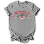 A heather gray short-sleeve t-shirt with a 'Nutcracker Sewing Club' graphic on the chest, featuring a nutcracker soldier, green script text, and a red spool of thread, shown on a white background.