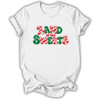 A white short-sleeve crewneck t-shirt with a festive graphic reading 'LAND of the SWEETS' in red and green candy-cane-style lettering, shown on a plain white background.