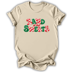 A beige short-sleeve t-shirt with a 'LAND of the SWEETS' graphic printed on the chest in red and green candy cane and peppermint font, displayed on a clean white background.