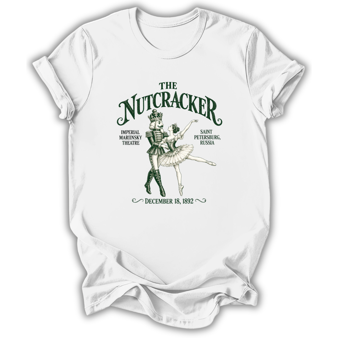 A white short-sleeve crewneck t-shirt featuring a vintage-style green graphic print of 'The Nutcracker' ballet, showing an illustration of the characters with text detailing the premiere venue and date.