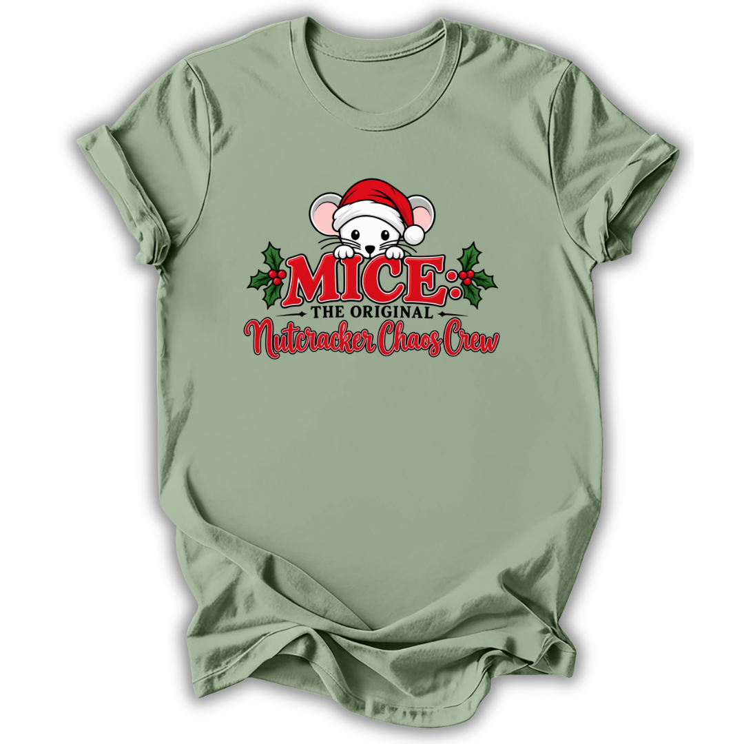 A sage green short-sleeve t-shirt with a festive graphic on the chest. The graphic features a cartoon mouse wearing a red Santa hat, flanked by red text reading 'MICE THE ORIGINAL Nutcracker Chaz Craw' and green holly leaves, set against a plain white background.