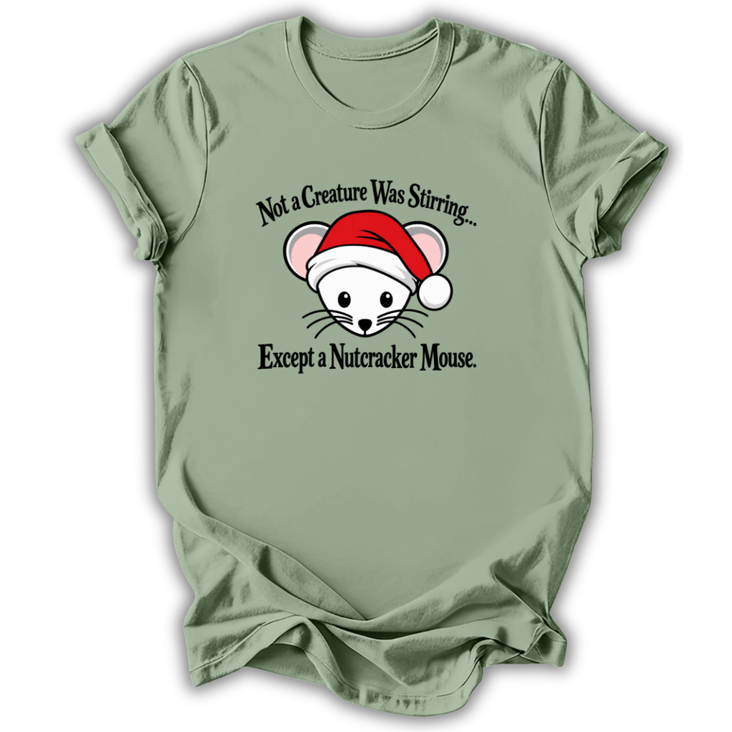 A sage green short-sleeve t-shirt with a graphic of a white nutcracker mouse wearing a red Santa hat, with the text 'Not a Creature Was Stirring.