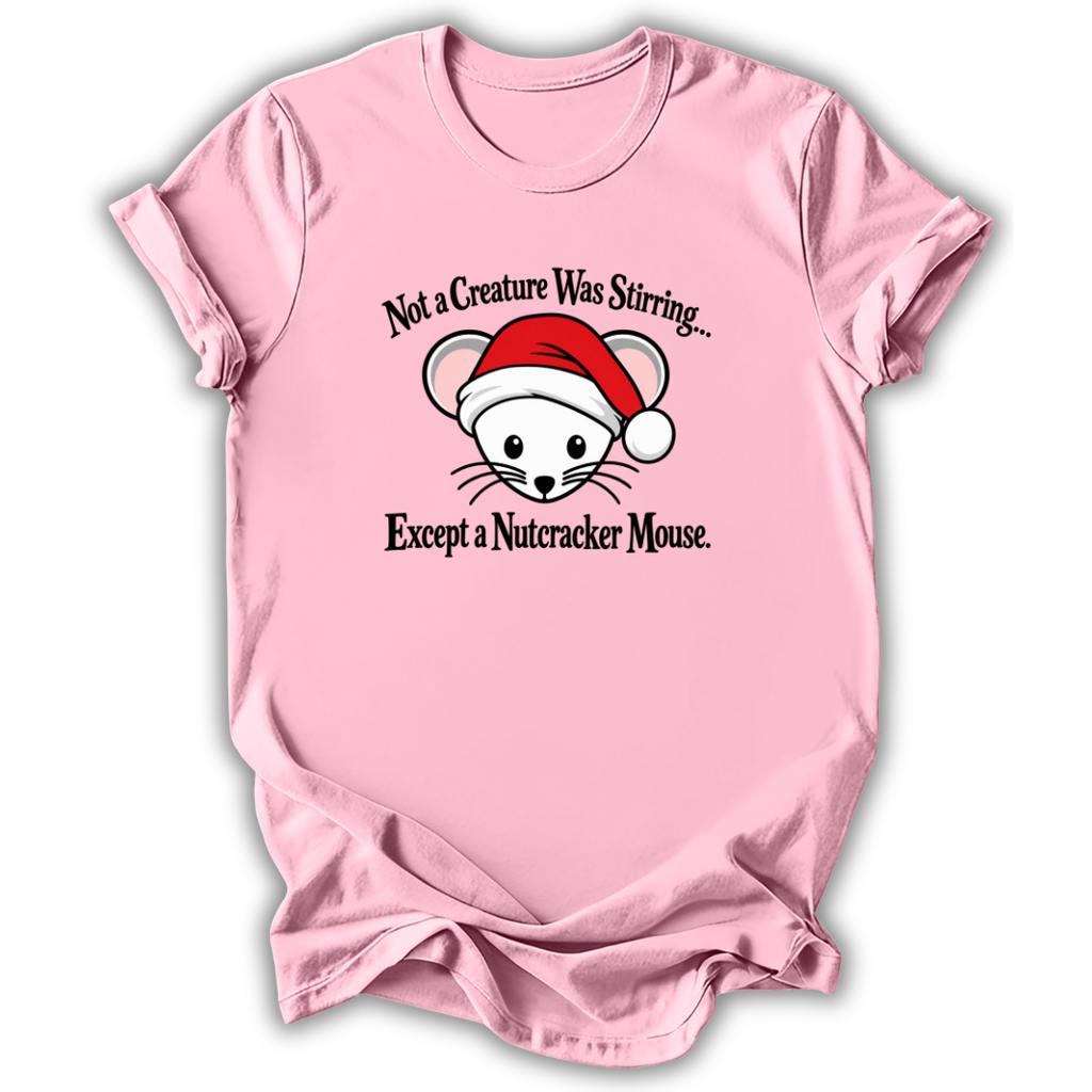 A light pink short-sleeve t-shirt with a graphic of a white nutcracker mouse wearing a red Santa hat, with the text 'Not a Creature Was Stirring.