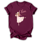 A maroon short-sleeve t-shirt with a graphic of a ballerina in a pink dress and the text 'Clara The Nutcracker' printed on the front, displayed on a clean white background.