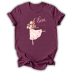 A maroon short-sleeve t-shirt with a graphic of a ballerina in a pink dress and the text 'Clara The Nutcracker' printed on the front, displayed on a clean white background.