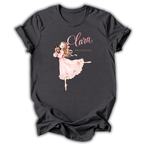 A dark charcoal gray t-shirt featuring a graphic of a ballerina in a pink dress holding a nutcracker, with the text 'Clara' and 'The Nutcracker' printed on the front.