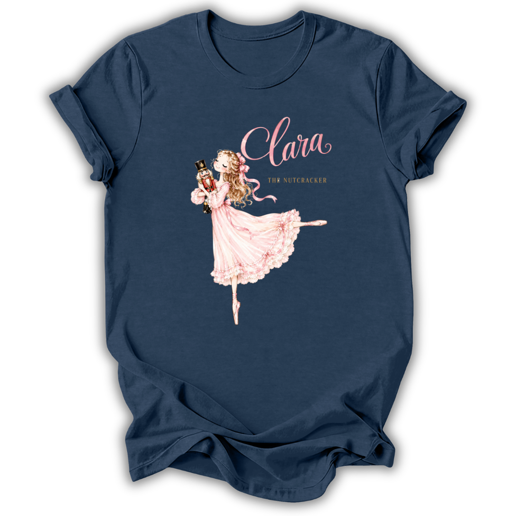 A navy blue short-sleeve t-shirt with a graphic print of a ballerina in a pink dress and the text 'Clara The Nutcracker'.