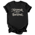 A black short-sleeve t-shirt with a white graphic text print reading 'Nutcracker Magic Starts Backstage' in a decorative script font, shown against a plain white background.