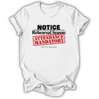 A white short-sleeve crewneck t-shirt with a graphic print that reads 'NOTICE Rehearsal Season: ATTENDANCE MANDATORY' in black and red text, styled as a flat lay on a white background.