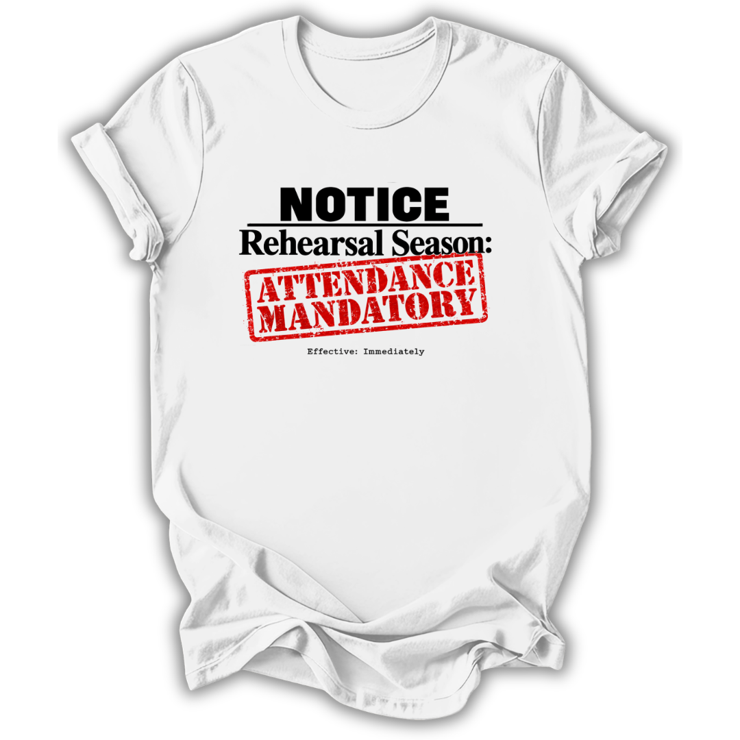 A white short-sleeve crewneck t-shirt with a graphic print that reads 'NOTICE Rehearsal Season: ATTENDANCE MANDATORY' in black and red text, styled as a flat lay on a white background.