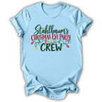 A light blue short-sleeve crewneck t-shirt with a graphic print reading 'Stahlbaum's Christmas Eve Party CREW' in green and red lettering, decorated with colorful Christmas lights, shown on a white background.
