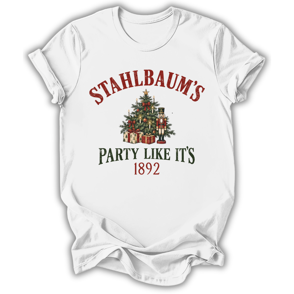 A white short-sleeve t-shirt with a Christmas-themed graphic print. The design features the text 'STAHLBAUM'S PARTY LIKE IT'S 1892' in red and dark green lettering, surrounding an illustration of a decorated Christmas tree with gifts and nutcrackers.