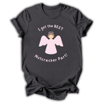 A dark charcoal gray t-shirt with a graphic of a pink angel and the text 'I got the BEST Nutcracker Part!' printed on the front, displayed on a clean white background.