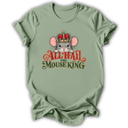 A sage green short-sleeve t-shirt with a graphic of a cartoon mouse wearing a red and gold crown, above the text 'ALL HAIL THE MOUSE KING' in red and dark green lettering.