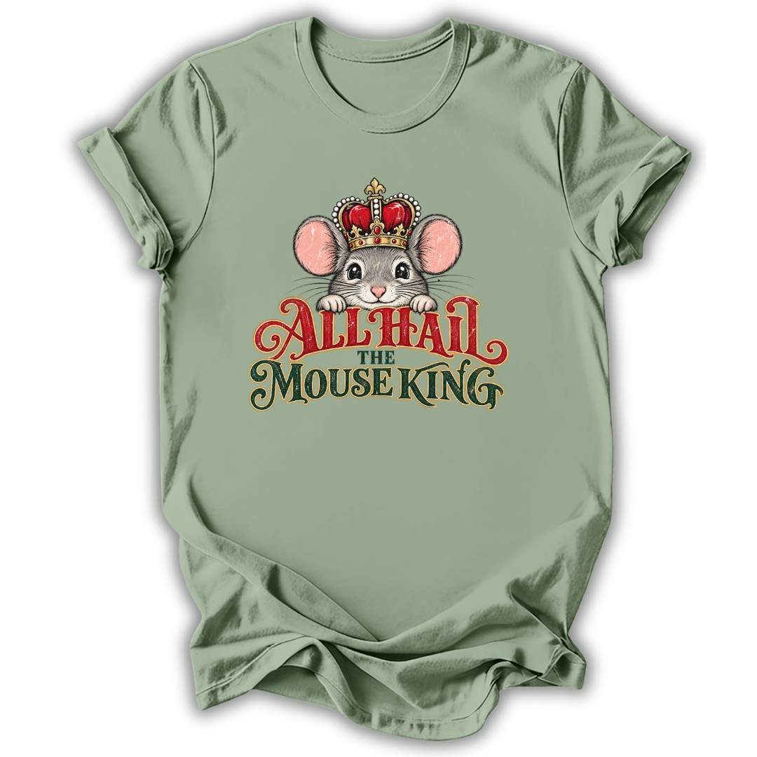 A sage green short-sleeve t-shirt with a graphic of a cartoon mouse wearing a red and gold crown, above the text 'ALL HAIL THE MOUSE KING' in red and dark green lettering.