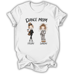 A white short-sleeve crewneck t-shirt with a graphic print on the front. The graphic features the text 'DANCE MOM' above two cartoon women labeled 'FRIDAY' and 'SUNDAY', dressed in black and gray respectively and holding coffee cups.