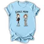 A light blue short-sleeve t-shirt with a graphic print that reads 'DANCE MOM' above two cartoon women labeled 'FRIDAY' and 'SUNDAY', shown on a plain white background.