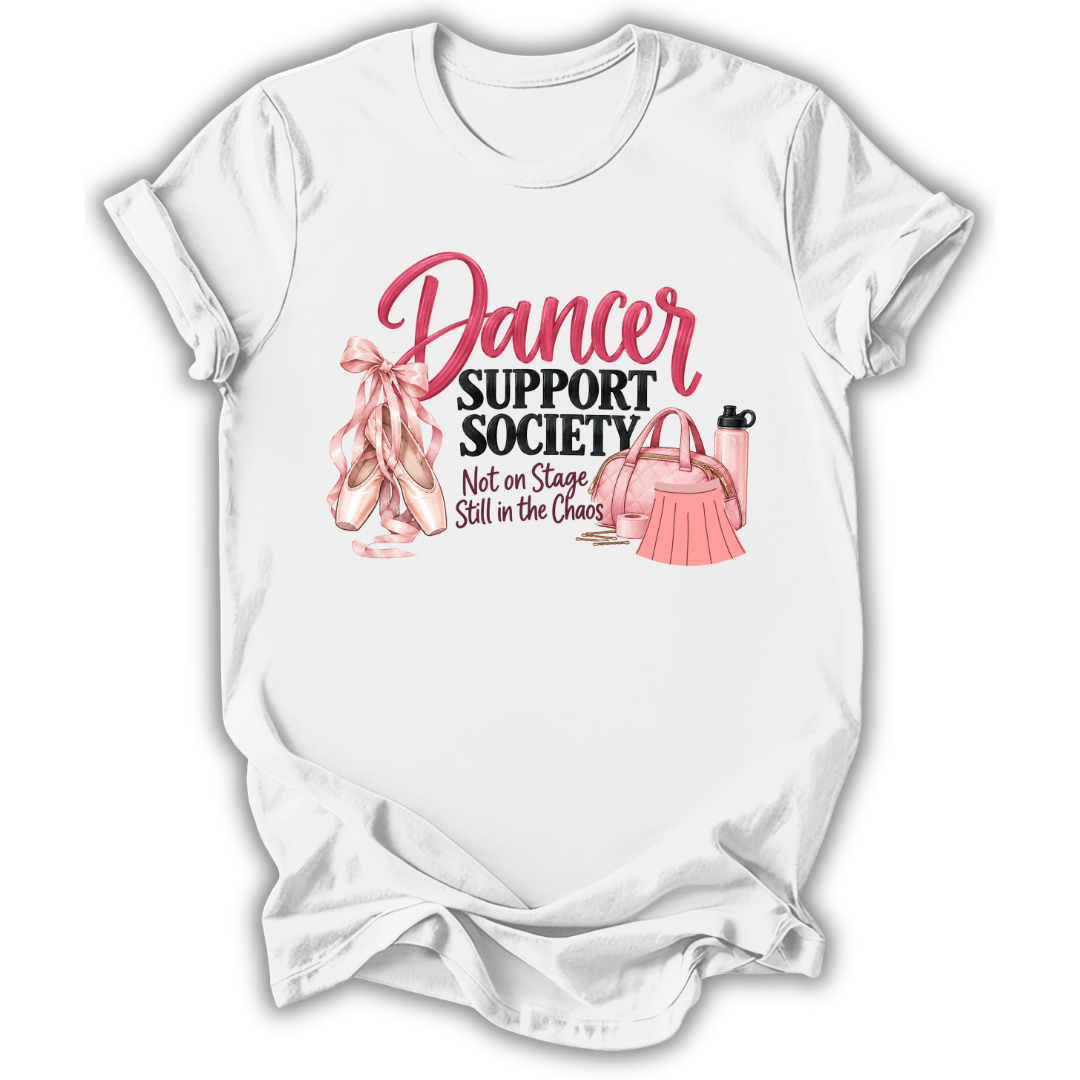 A white short-sleeve t-shirt with a graphic print on the front that reads 'Dancer Support Society Not on Stage Still in the Chaos' in pink and black lettering, accompanied by illustrations of pink ballet slippers, a pink handbag, and a pink water bottle.