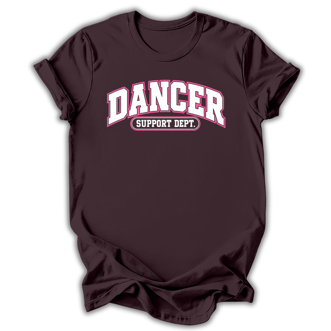 A dark maroon short-sleeve t-shirt with 'DANCER SUPPORT DEPT.' printed in white and pink on the chest, displayed against a clean white background.