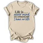 A beige short-sleeve t-shirt with a humorous gymnastics-themed graphic printed on the front. The text reads 'Life is.