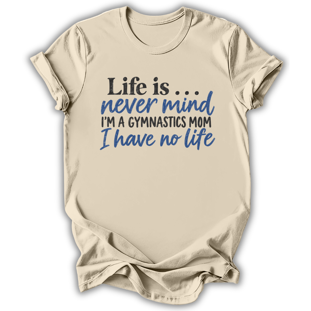 A beige short-sleeve t-shirt with a humorous gymnastics-themed graphic printed on the front. The text reads 'Life is.