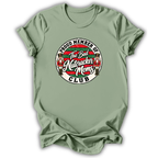 A sage green short-sleeve t-shirt with a circular graphic on the chest that reads 'Proud Member of The Bad Nutcracker Moms Club' featuring nutcracker illustrations.