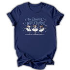 Navy short-sleeve t-shirt with a graphic print of three ballerinas and the text 'I'm Dreaming While Christmas' in blue and white, displayed on a clean white background.