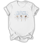 A white short-sleeve t-shirt with a graphic print of three ballerinas and the text 'I'm Dreaming While Christmas' in blue and white, displayed on a clean white background.