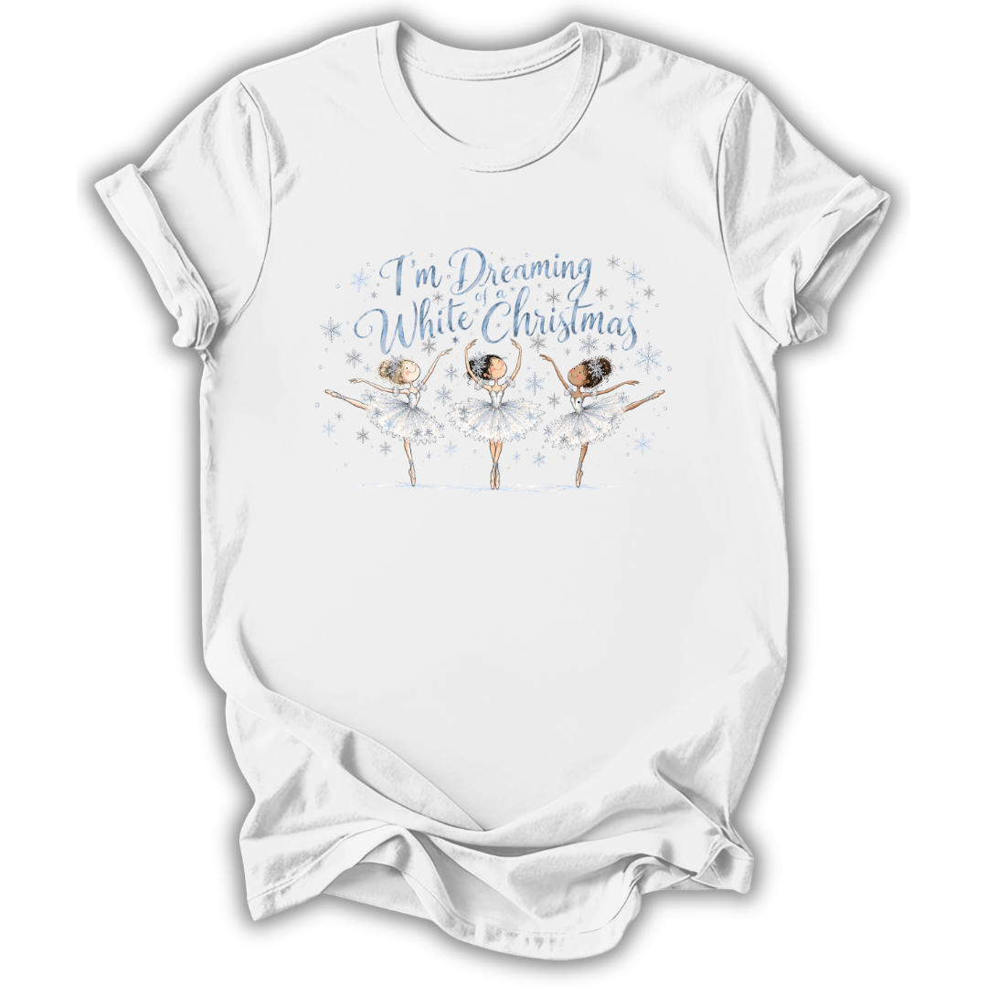 A white short-sleeve t-shirt with a graphic print of three ballerinas and the text 'I'm Dreaming While Christmas' in blue and white, displayed on a clean white background.