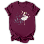 A maroon short-sleeve t-shirt with a graphic of a ballerina and the text 'Let Every Heart Dance with Joy' in white and light blue, displayed on a clean white background.