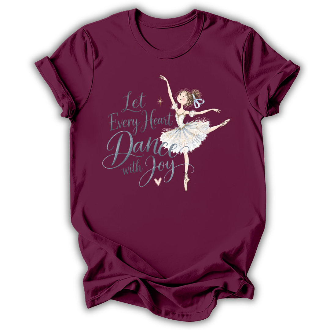 A maroon short-sleeve t-shirt with a graphic of a ballerina and the text 'Let Every Heart Dance with Joy' in white and light blue, displayed on a clean white background.
