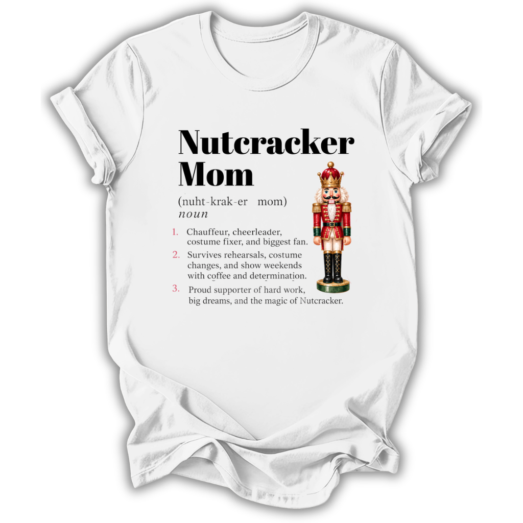 A white short-sleeve crewneck t-shirt with a graphic print on the front. The print features the text 'Nutcracker Mom' in bold black font, followed by a phonetic definition and a list of three characteristics.
