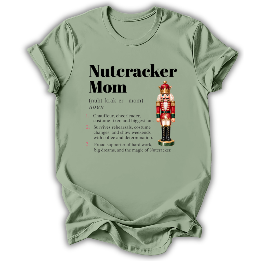 A sage green short-sleeve t-shirt printed with the “Nutcracker Mom Definition” graphic design.