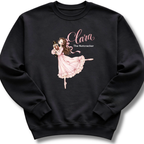 A black crewneck sweatshirt featuring an illustration of Clara in a graceful pink ballet pose with delicate 'The Nutcracker' lettering.