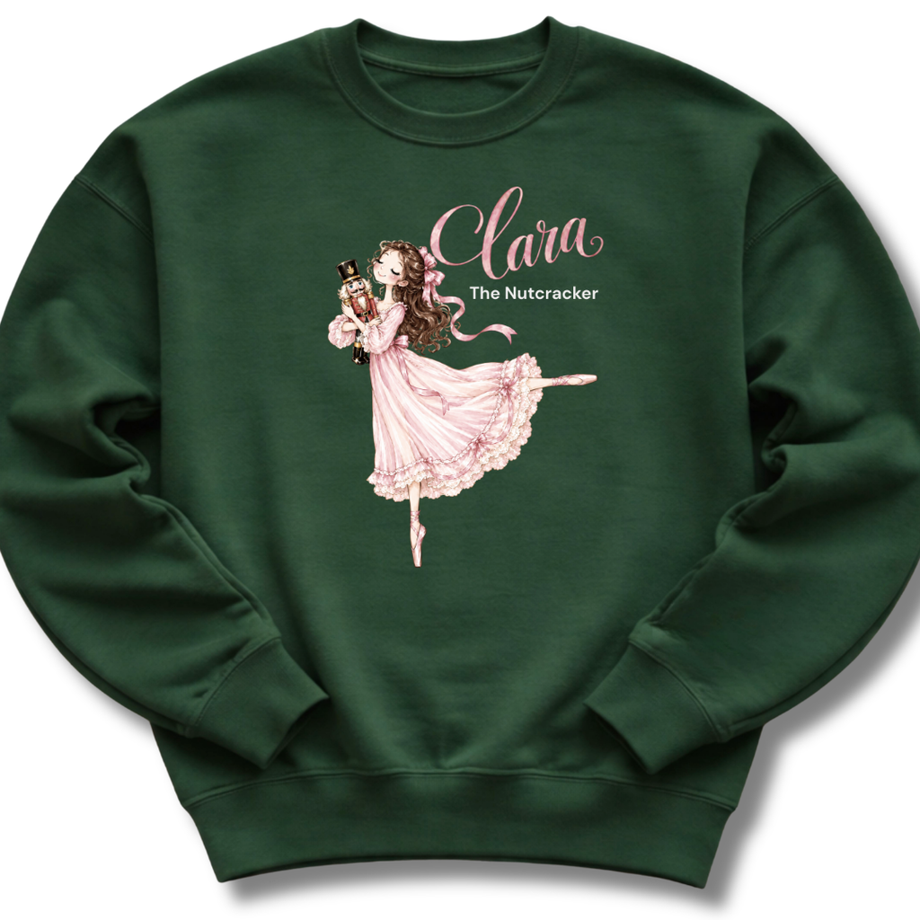 A forest green youth crewneck sweatshirt featuring an illustration of Clara in a graceful pink ballet pose with delicate 'The Nutcracker' lettering.